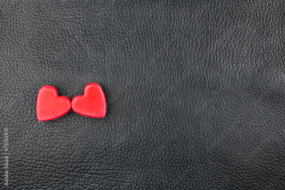 Obraz premium The concept of two lovers hearts lying on the natural leather