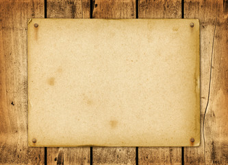 Blank vintage poster nailed on a wood board