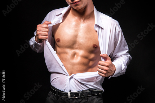 Photos Muscular man showing his chest during striptease