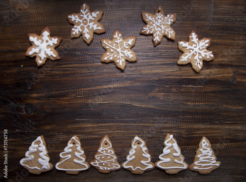 Christmas background with cookies decorated with icing , on a wo