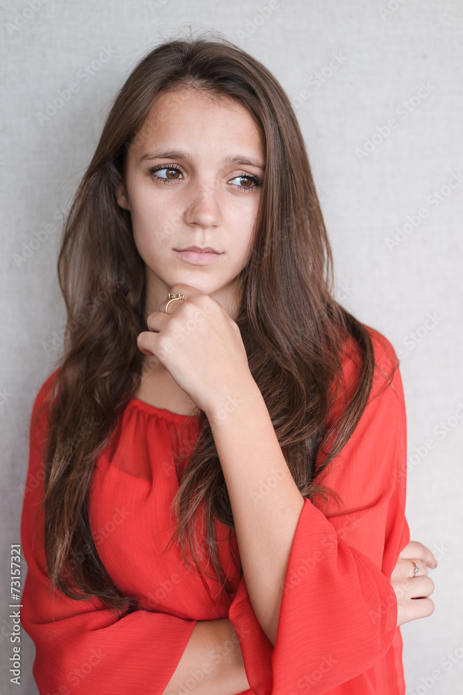 Beautiful young attractive woman holding her chin Beautiful young attractive woman holding her chin