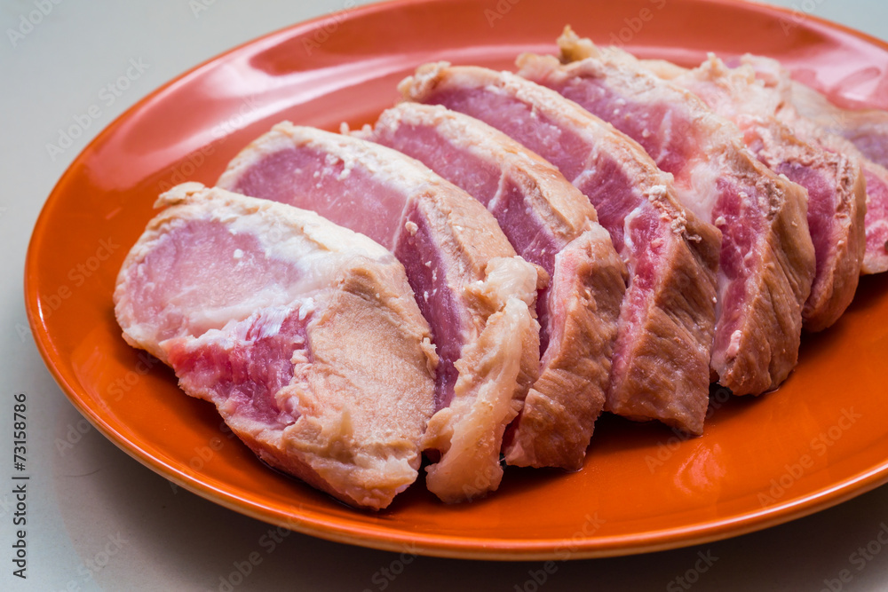 Raw sliced pork in the orange dish - Ingredient