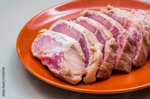 Raw sliced pork in the orange dish - Ingredient