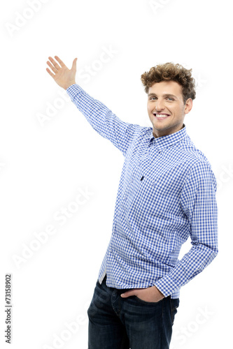 Portrait of a handsome young man gesturing welcome