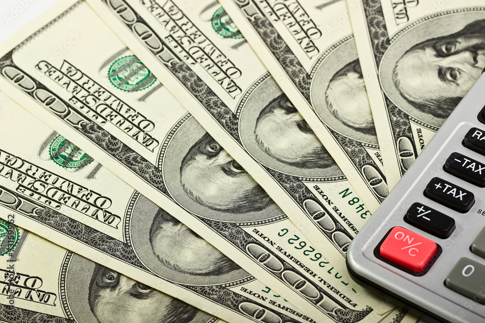 Fototapeta premium Banknote hundred dollars and calculator