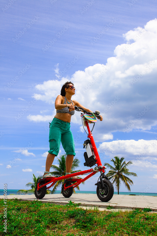 Woman on an electric tricycle in Miami Woman on an electric tricycle in Miami
