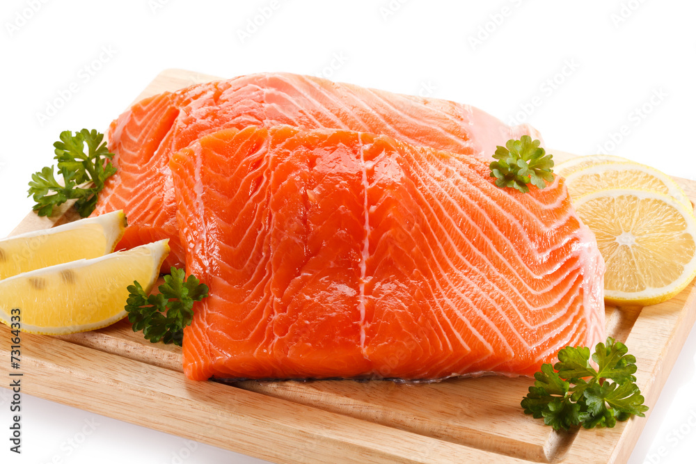 Fresh raw salmon fillet on cutting board Fresh raw salmon fillet on cutting board