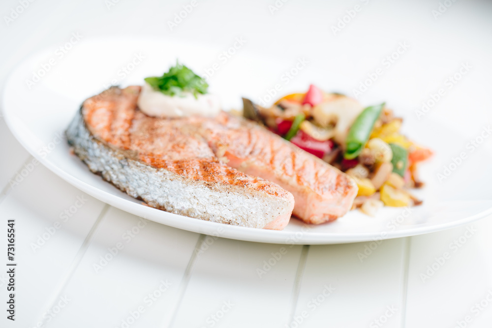 Grilled Salmon with Fresh vegetables on white background