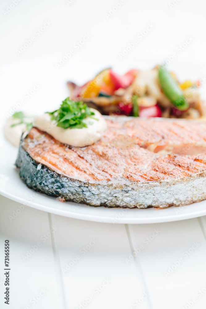 Grilled Salmon with Fresh vegetables on white background Grilled Salmon with Fresh vegetables on white background