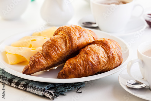 Croissants with cheese, fruits and coffee photo