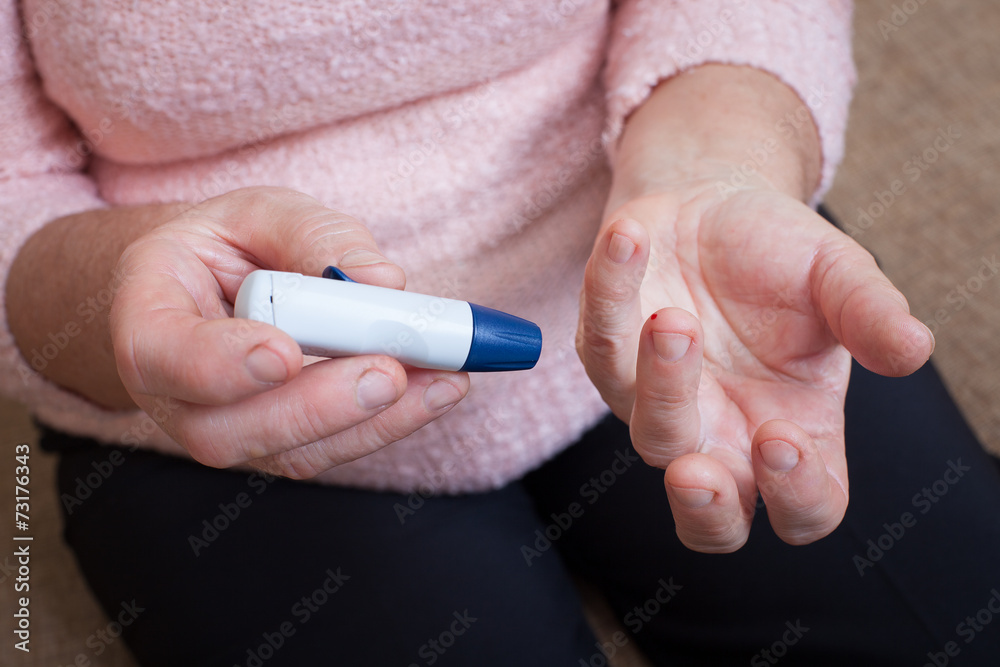 Woman testing for high blood sugar.
