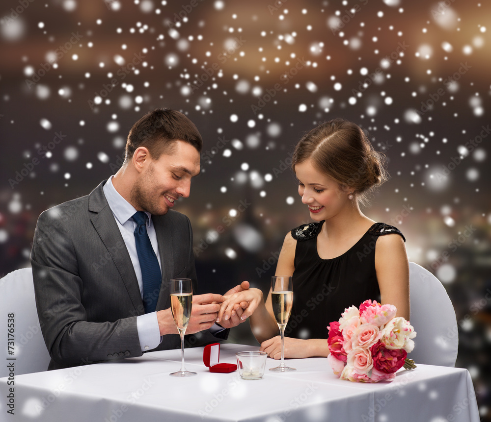 smiling couple with red gift box at restaurant smiling couple with red gift box at restaurant