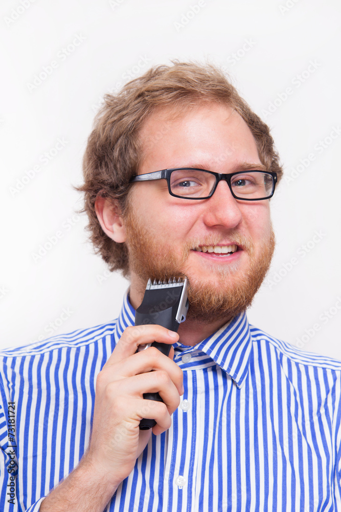Portret of bearded man with an electric razor Portret of bearded man with an electric razor
