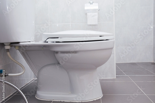 white flush toilet in modern bathroom interior