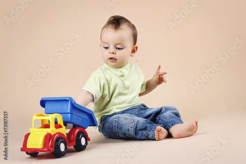 Little boy playing with car