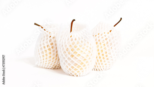three apple pears in packing protective net isolated on white ba