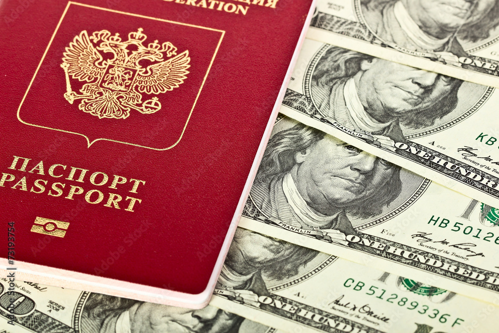 Naklejka premium Russian passport lies on US dollars