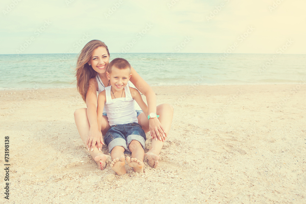 Mother and her son having fun on the beach Mother and her son having fun on the beach