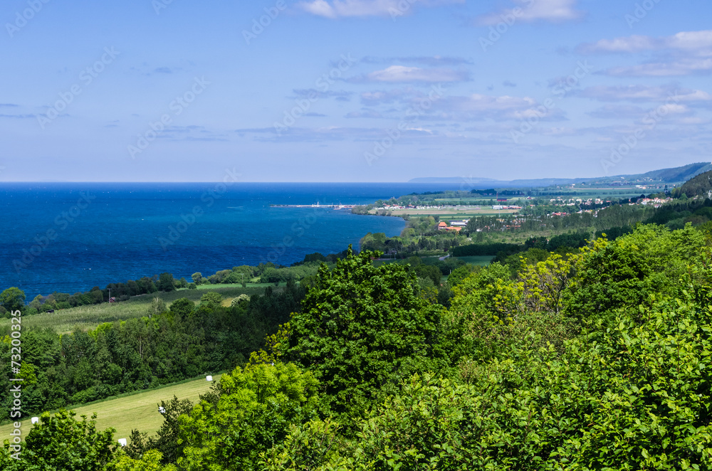 View of a lush landscape and the lake Vättern. View of a lush landscape and the lake Vättern.