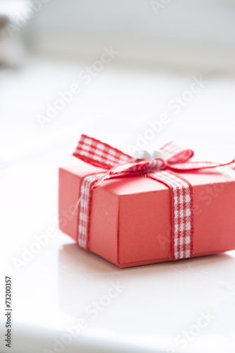 Single red gift box with ribbon