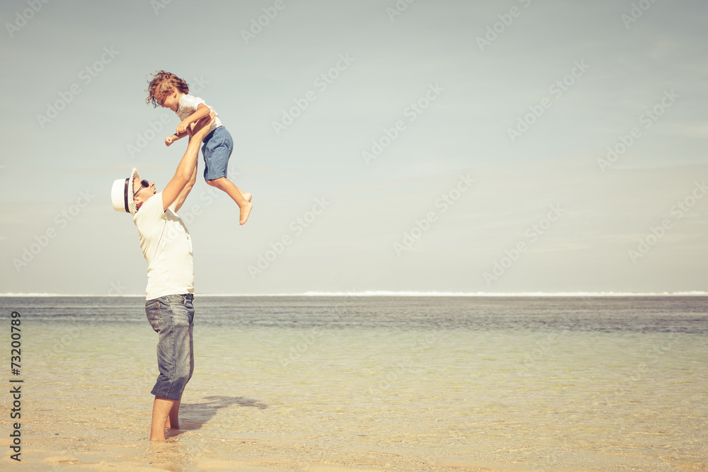 father and son playing on the beach