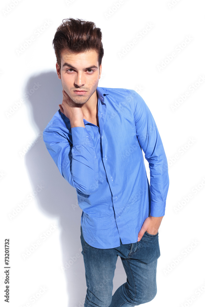 Fashion man holding one hand to his neck Fashion man holding one hand to his neck