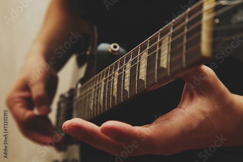 Man playing on guitar photo