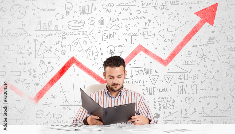 Business man sitting at table with market diagrams Business man sitting at table with market diagrams