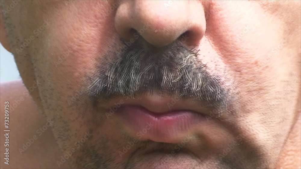 man eats red currants with appetite