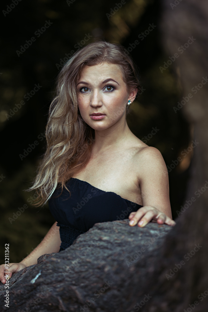 Beautiful young woman in ball gown at tree Beautiful young woman in ball gown at tree