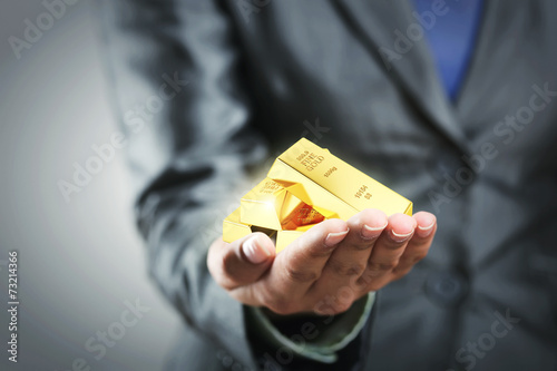 Golden bars on the woman's hand photo