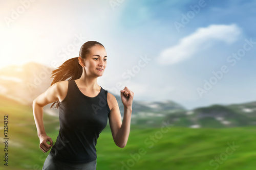 Woman running on green grass