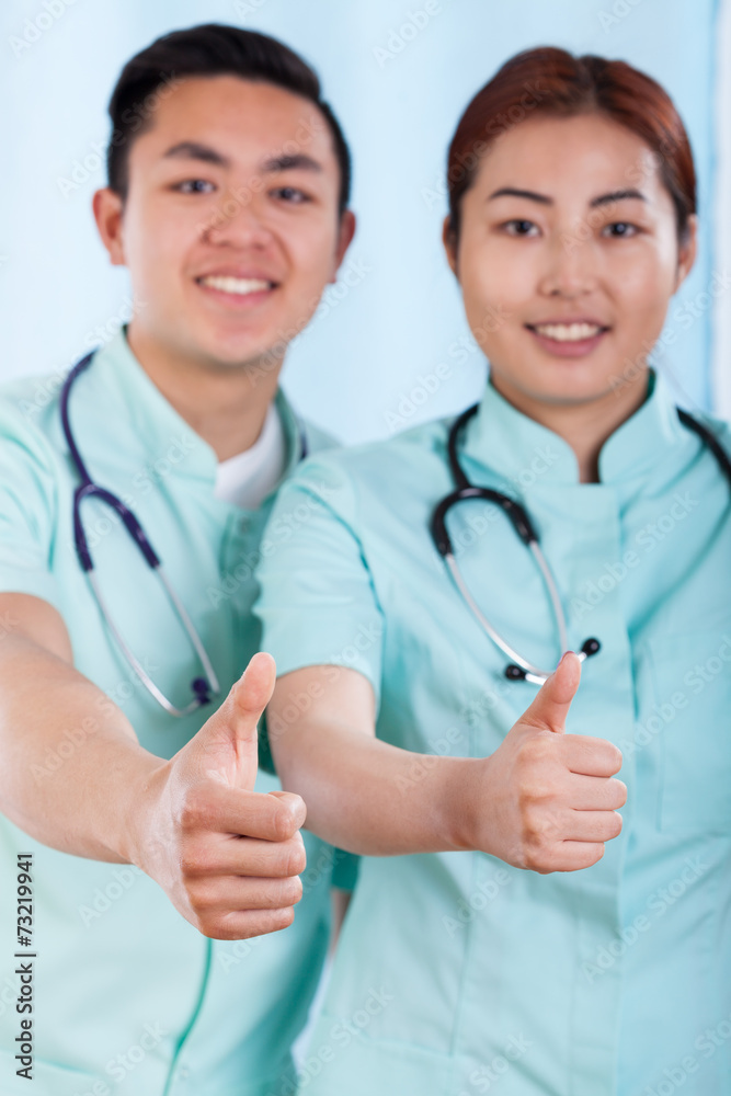 Couple of doctors with okay gesture Couple of doctors with okay gesture