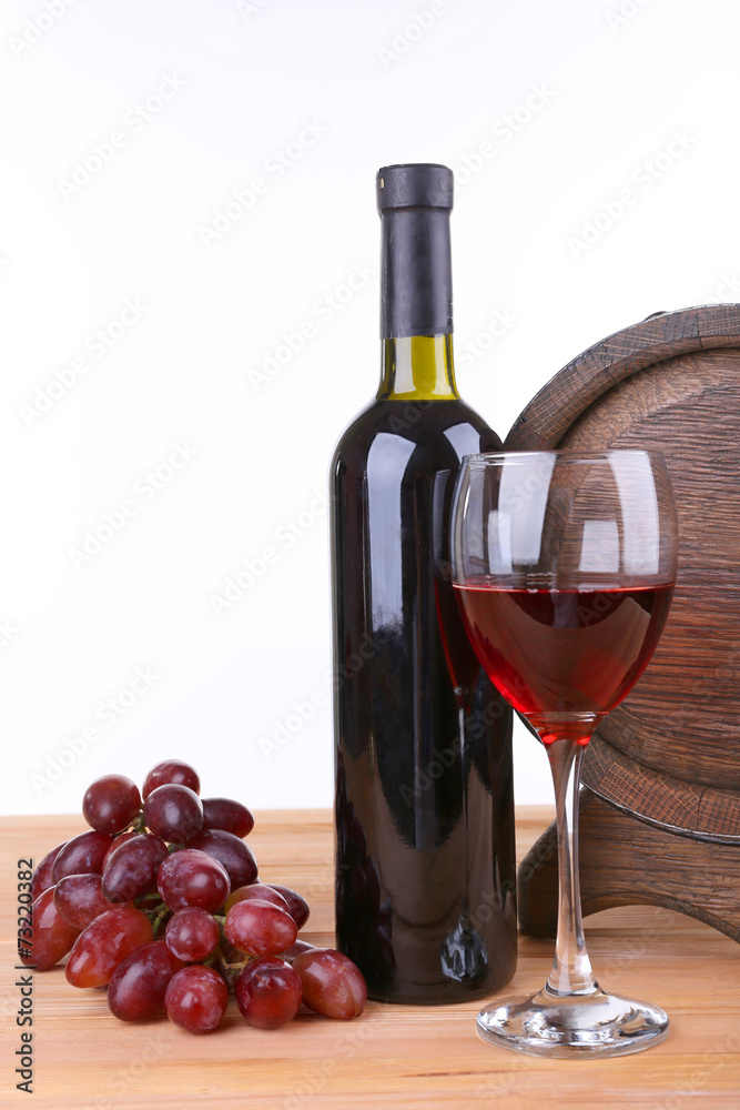 Wine in goblet and in bottle, grapes and barrel