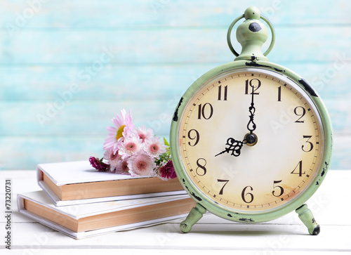 Fototapeta Naklejka Na Ścianę i Meble -  Beautiful flowers with clock and book