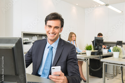 Businessman at his desk wit...