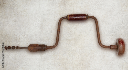 Old hand drill carpenter tool isolated photo