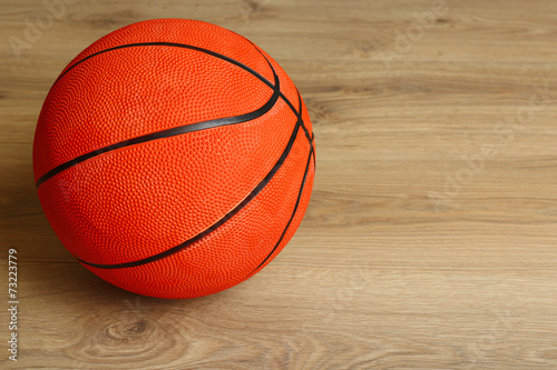 Basketball ball on wooden background © Africa Studio