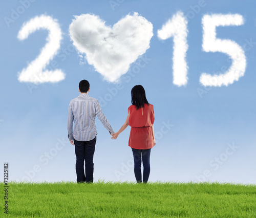 Couple holding hands on the meadow