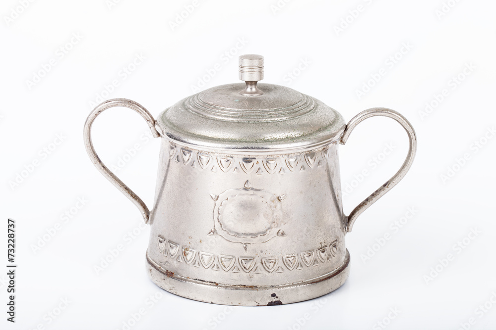 old sugar bowl with lid and spoon with spots of rust on a white old sugar bowl with lid and spoon with spots of rust on a white