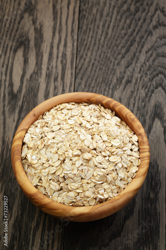 oat flakes in wood bowl on oak table
