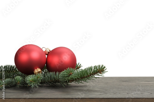 traditional red balls and fir branch on wood table