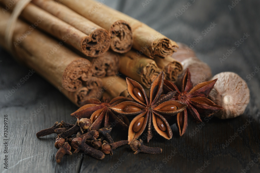 bunch of cinnamon sticks with nutmeg, anise and cloves bunch of cinnamon sticks with nutmeg, anise and cloves