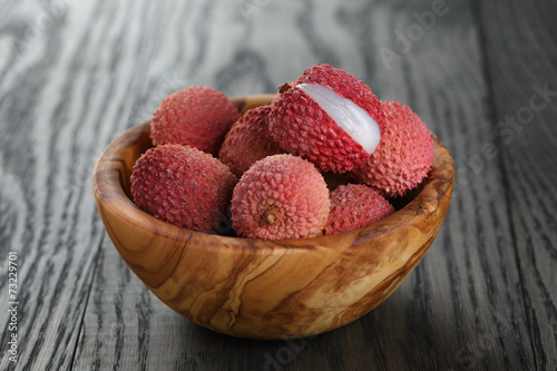 ripe lychees in wood bowl