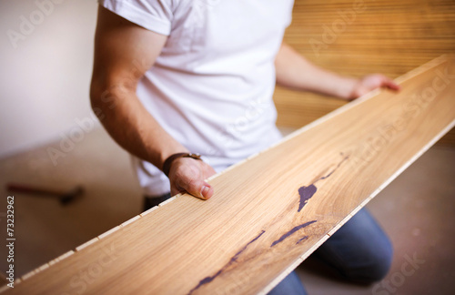 Handyman installing wooden floor