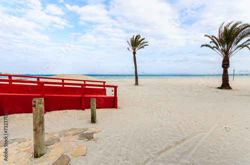 Red footbridge on sandy Alcudia beach, Majorca island, Spain