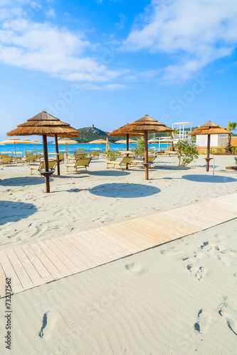 Sunchairs with umbrellas on Porto Giunco beach  Sardinia island