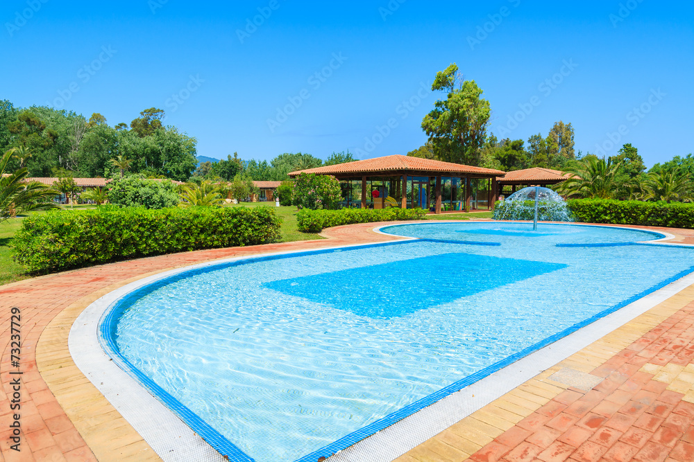 Swimming pool in tropical garden on Sardinia island, Italy