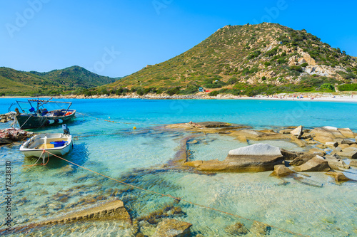 Fishing boat on sea water at Punta Molentis bay, Sardinia island