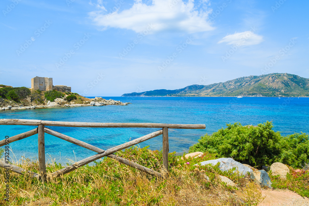 Wooden fence on coast of Sardinia island and sea view, Italy